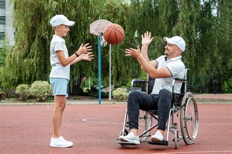 Dad Plays With His Disabled Son On The Sports Ground Concept