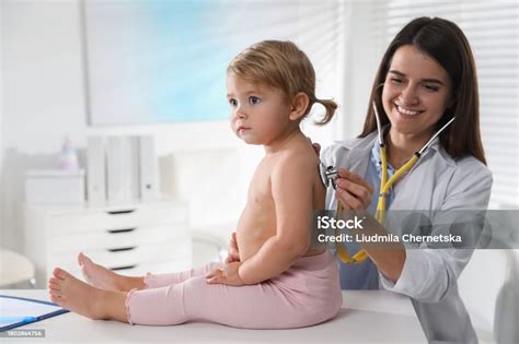 pediatrician examining baby  stethoscope  clinic stock photo