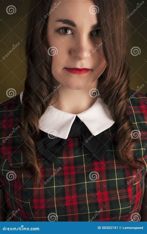 Cute Brunette In Tartan Dress With Red Lips And Curles Studio Portrait