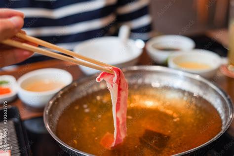 Sukiyaki Shabu Shabu Japanese Food Hot Pot With Close Up Hand Hold Chopsticks Pinch Marble Fresh