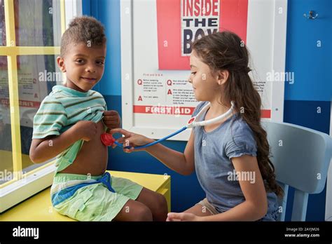 Two Children Playing Doctor In Playroom Stock Photo Alamy