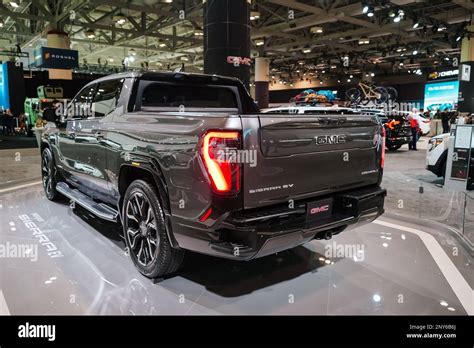 GMC Sierra EV, electric version of the popular GMC pickup truck, on display at a car show Stock ...