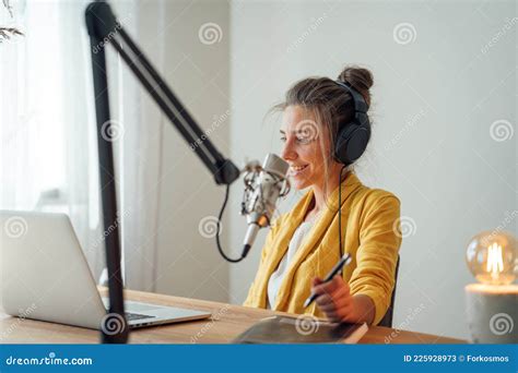 Female Radio Host Streaming Podcast Using Microphone And Laptop At His