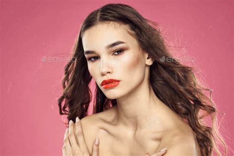 Beautiful Woman With Red Lips On A Pink Background Nude Shoulders