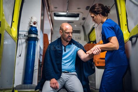 Man Sits In Blanket Doctor In Medical Uniform Holds His Hand In The