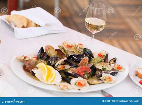 Clams and Glass of White Wine Stock Photo - Image of served, shell ...