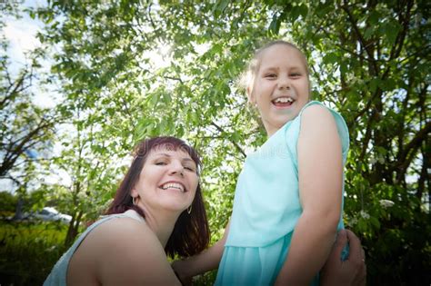 Happy Mother And Daughter Enjoying Rest Playing And Fun On Nature On A