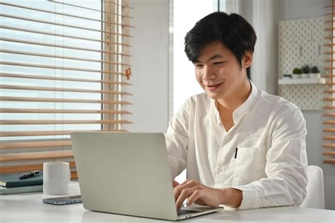 Premium Ai Image Portrait Of Smiling Asian Male Entrepreneur Sitting