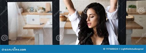 Shot Of Girl In Black Underwear And White Shirt Holding Room Divider