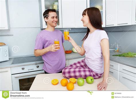 Couple Drinking Orange Juice In The Kitchen Stock Photo Image Of