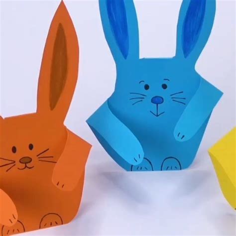 Three Paper Rabbits Sitting Next To Each Other