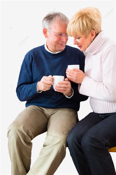 Elderly Individuals Enjoying Tea By The Fire In The Comfort Of Their