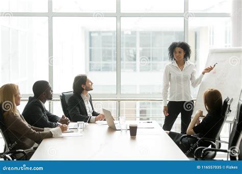 African American Businesswoman Giving Presentation To Executive Stock