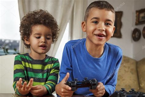 Two Friends Playing Video Game Stock Photo By ©milicac 64599463