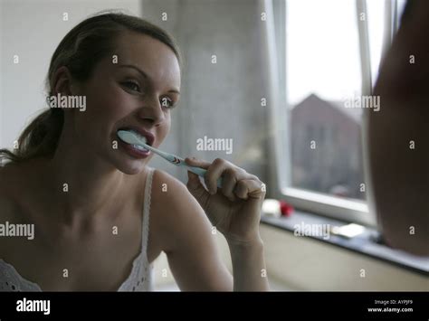 A Blonde Woman Brushing Her Teeth Stock Photo Alamy