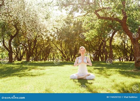 Young Red Hair Woman Peacefully Meditating In Park Stock Photo Image