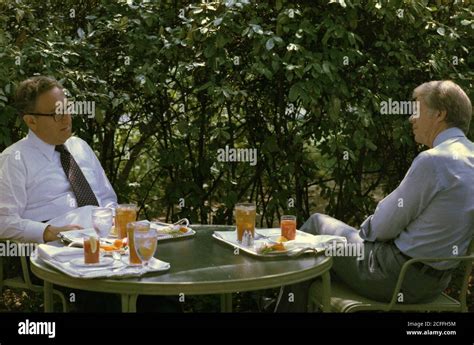 Henry Kissinger and Jimmy Carter during a lunch meeting on the White House patio. ca. 15 August ...