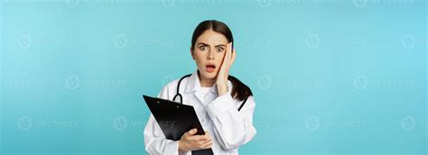 Shocked woman doctor reacting worried and frustrated at camera, hear