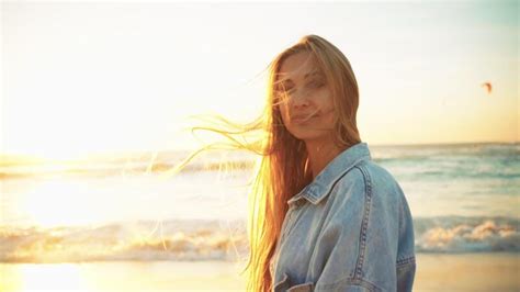 Blonde Woman Enjoying Sunset By Ocean Stock Video At Vecteezy