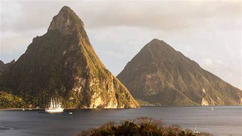 Boats Are In The Water Near Some Mountains