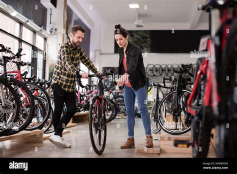 small business owner serving customer   bike store stock photo alamy