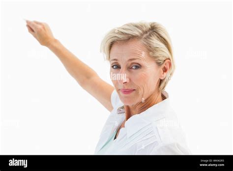 Happy Mature Blonde Writing And Smiling On White Background Stock Photo