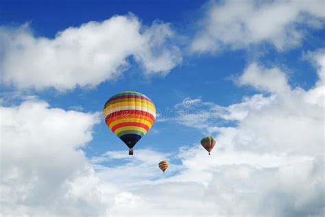 Colorful Hot Air Balloon Rise Up Into Blue Sky Above White Cloud Stock