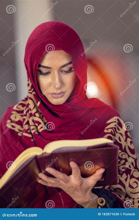 Young Muslim Woman Reading Quran In The Mosque And Sunlight Falling ...