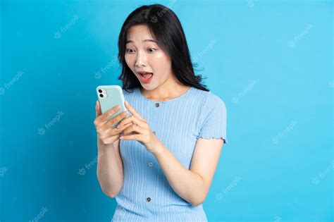 Premium Photo Portrait Of Smiling Asian Woman Posing On Blue Background