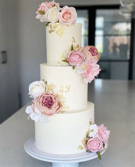 Elegant Three Tiered Wedding Cake With Pink And White Flowers