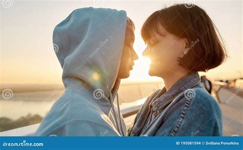Lesbian Couple Hugging On The Bridge Looking At Each Other Before Kiss While Admiring The