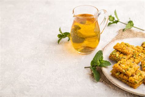 Traditional Iranian Dessert Sohan with Glass of Green Tea on a Gray ...