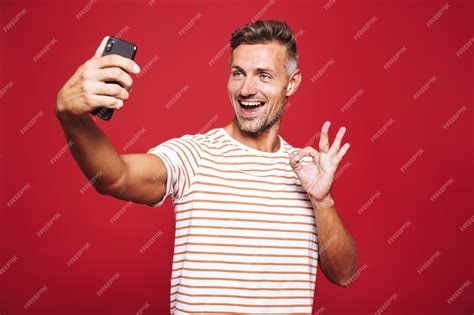 Premium Photo Portrait Of A Cheerful Man Standing On Red