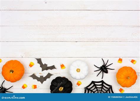 Halloween Bottom Border with Black, Orange and White Decor and Candy Over White Wood Stock Photo ...