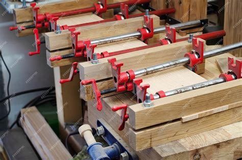 Premium Photo | Red joiner39s clamps are fixed on product gluing of ...