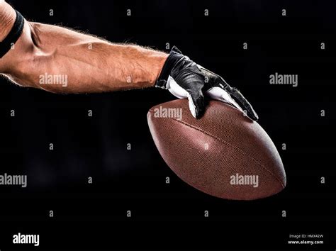 Football player holding ball Stock Photo - Alamy