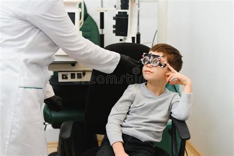 Cheerful Child Boy In Glasses Checks Eye Vision Pediatric