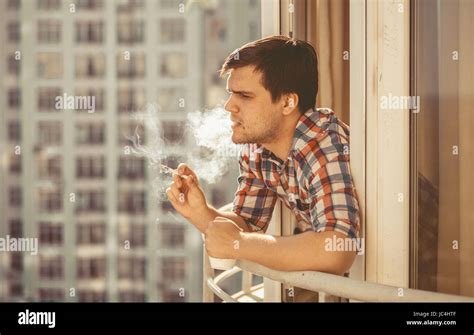 Toned Portrait Of Hipster Guy Smoking Cigarette And Drinking Coffee