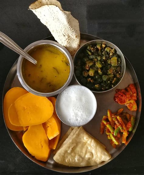 A Typical Gujarati Meal Tur Dal Bhindi Sliced Mango Roti Papad