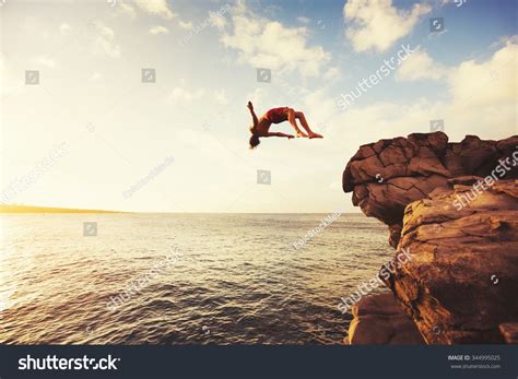 Cliff Jumping Into The Ocean At Sunset Summer Fun Lifestyle