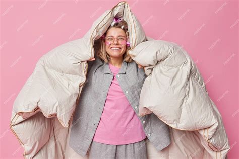 Free Photo Positive Cheerful Young Woman Wrapped In Duvet Has Happy