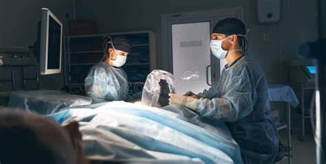 Doctor And An Assistant In Operating Room For Surgical Clinic Stock