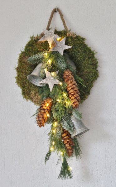 A Christmas Wreath With Pine Cones And Lights