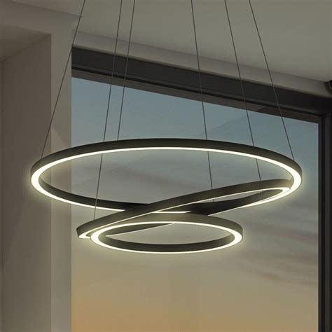 A Circular Light Fixture Hanging From The Ceiling In Front Of A Window