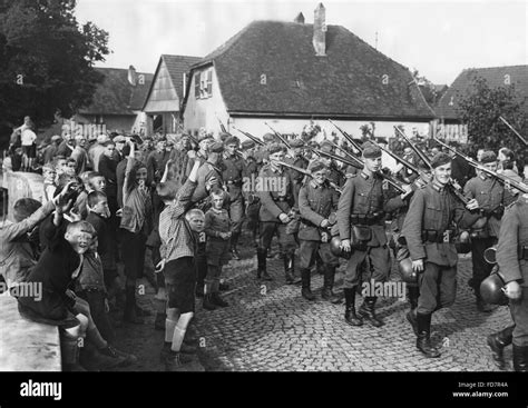 German Infantry Marches Through A Village During A Maneuver 1936 Stock