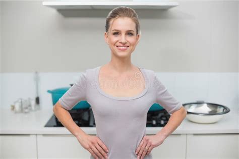 Smiling Gorgeous Blonde Standing Hands On Hips Looking At Camera Stock