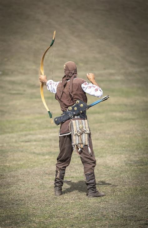 Young Man Shooting an Arrow in a Nature Editorial Stock Image - Image ...