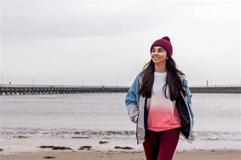 Teenage Girl Walking Alone On Beach Stock Photo - Download Image Now ...