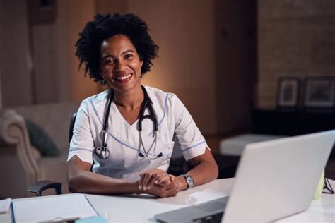 Portrait Of Smiling African American Female Doctor At Her Office HSF UK