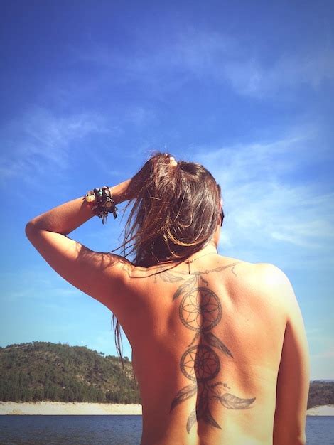 Premium Photo Rear View Of Naked Woman With Dreamcatcher Tattoo On